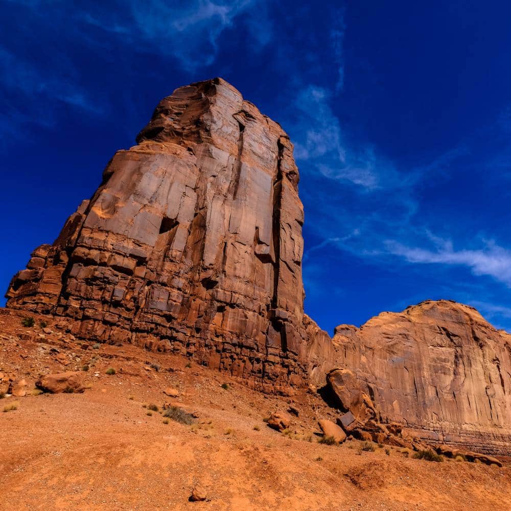 Low angle shot of big desert rocks with blue sky in the background